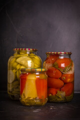Jars of canned vegetables on a wooden background . Homemade vegetables for the winter