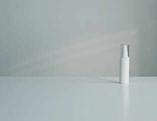 Plastic cosmetic packaging bottle mock up with pump dispenser on white background. Copy space.