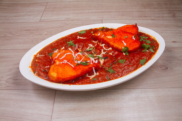 Paneer Butter Masala or Cheese Cottage Curry, popular Indian lunch or dinner menu served on a moody background, selective focus