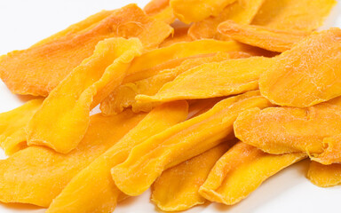 Many slices of dried mango close-up. Selective focusing at the center of the frame.