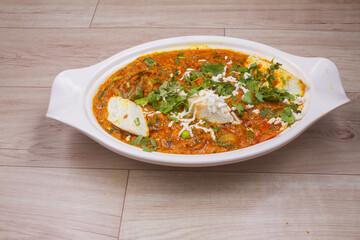indian dish Paneer masala or paneer lachhedar served in bowl on wooden background