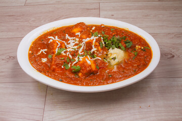 indian dish Paneer masala or paneer lachhedar served in bowl on wooden background