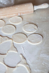Variki with meat and mushrooms. They lie on the table. Dough.