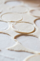 Variki with meat and mushrooms. They lie on the table. Dough.