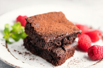 Chocolate brownies with raspberry and cocoa powder