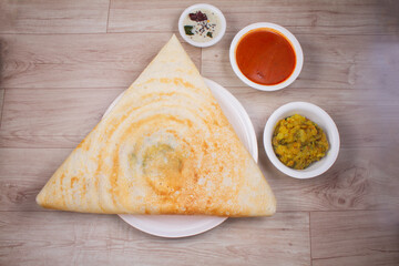 Masala dosa is a South Indian dish that is served with sambhar and coconut rubble. Selective focus