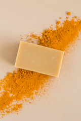 Bar of handmade turmeric soap with fresh turmeric