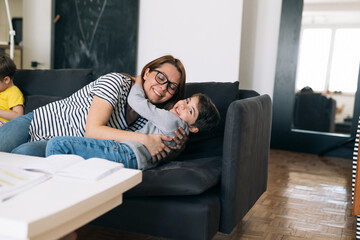 Obraz premium mother embracing with her son at home