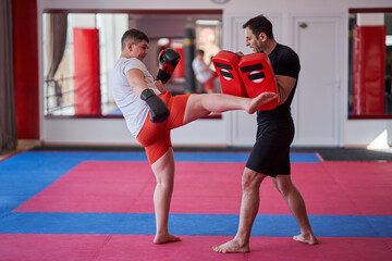 Overweight kickboxer with his trainer