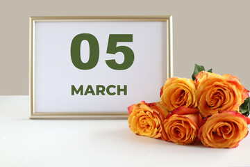 Fototapeta premium day of the month 05 March calendar photo frame and yellow rose on a white table