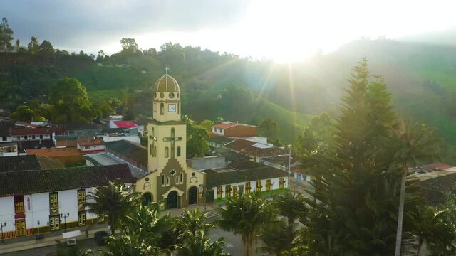 Beautiful View of Salento Cathedral at Sunrise with Palm Trees in Main Square at Dramatic Sunflare