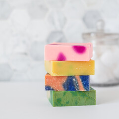 Stack of handmade soap bars in bathroom with copy space