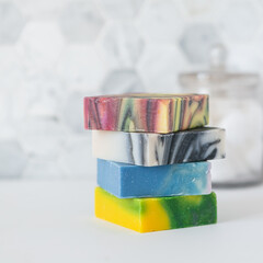 Stack of handmade soap bars in bathroom with copy space