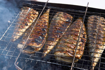 Mackerel fish on a grill, close-up. Grilled mackerel fish on bbq