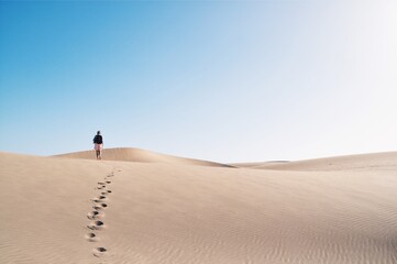 Fototapeta na wymiar A person walking in the desert