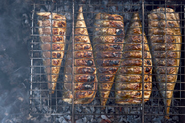 Mackerel fish on a grill, close-up. Grilled mackerel fish on bbq