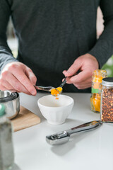 Turmeric spice with a model cooking in the kitchen