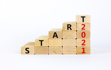 Business concept of 2021 new year start. Wooden blocks with words 'Start 2021'. Beautiful white...