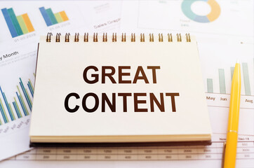 GREAT CONTENT written on notepad on financial charts and graphs with yellow pen.