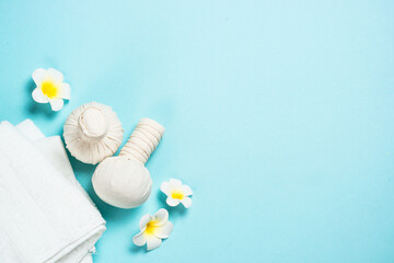 Spa herbal compressing balls on blue background. Flat lay image with copy space. Thai massage.