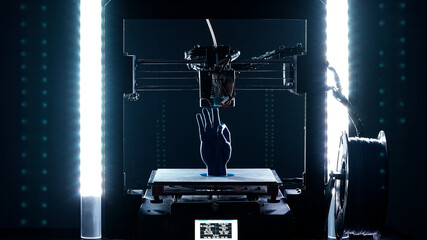 3d Printer printing blue hand sculpture