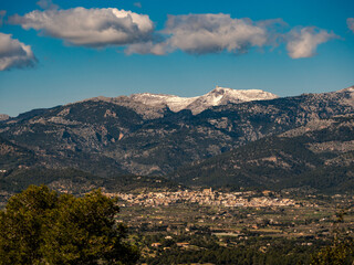 Fototapeta na wymiar panoramic view of the village of Campanet with the snow covered Puig Major in the Background on the balearic island of mallorca, spain
