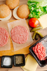 Ingredients for making burgers. Cooking burgers. Burger cutlets on a wooden board. Making burgers in your home kitchen