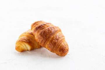 Fresh croissants on a white plate.