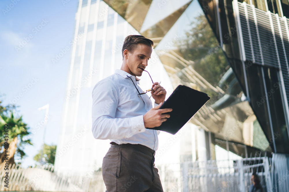 Poster side view of caucasian businessman browsing website with notification about financial transaction us