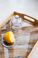 Handmade wood serving tray decorated with marble effect. Epoxy resin art decor. Background for DIY master class. Fluid art or acrylic decorative tray. Lemon in glass serving case. Banner web . High