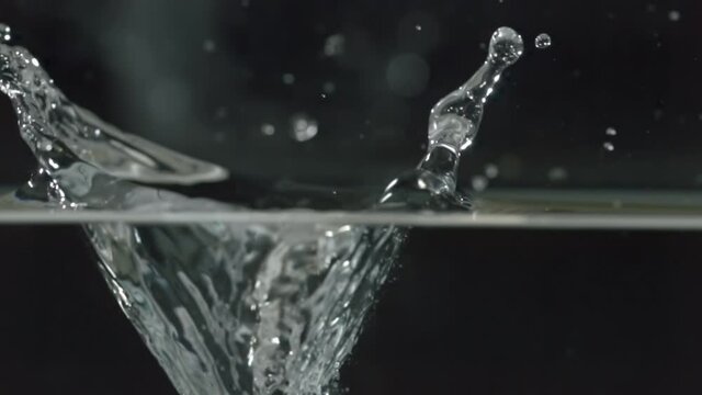 huge rock falls into water
