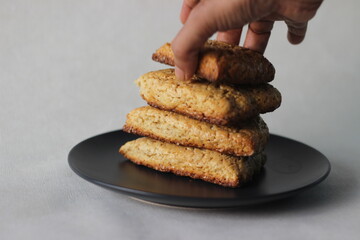 Home baked plain mildly sweet buttermilk scones, four of them stacked on a grey plate.