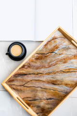 Handmade wood serving tray decorated with marble effect. Epoxy resin art decor. Magazine mock up. Background for DIY master class. Fluid art or acrylic decorative tray. A cup of coffee. High quality