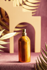presentation of godem perfume bottle next to geometric shapes and palm leaves