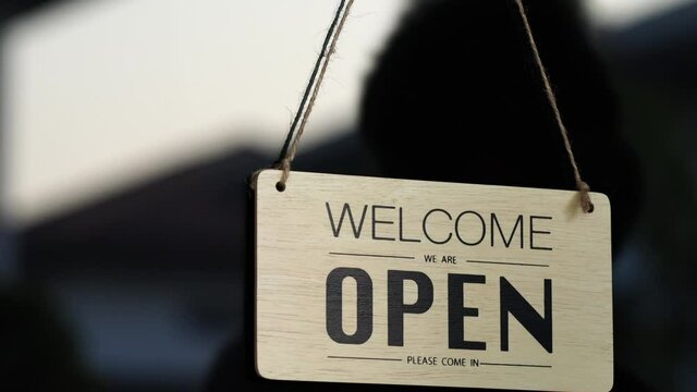 Cafes or restaurants and businesses reopened after the corona quarantine ended.
At the glass door There is a shadow of a man walking in to change the sign of the store From the original closed to open
