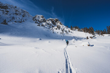 Mountaineer backcountry ski walking ski alpinist in the mountains. Ski touring in alpine landscape...
