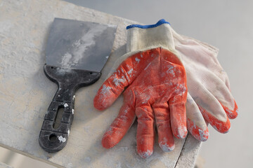 Renovation work concept, dirty gloves and shaper on wooden table
