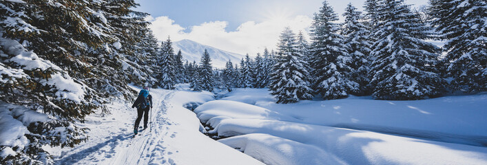 Mountaineer backcountry ski walking ski alpinist in the mountains. Ski touring in alpine landscape...