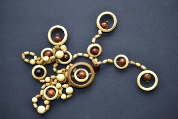 Wooden beautiful round beads on black background