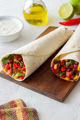 Burritos with meat, beans, corn, tomatoes, onions and chilli. Mexican food. Recipe.