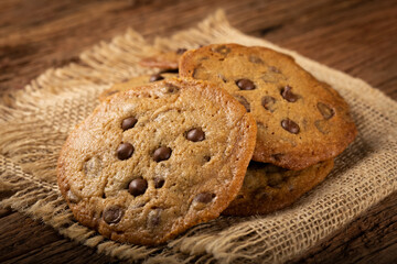 Delicious chocolate cookies on wooden table.