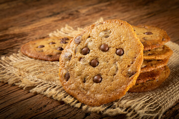 Delicious chocolate cookies on wooden table.