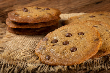 Delicious chocolate cookies on wooden table.