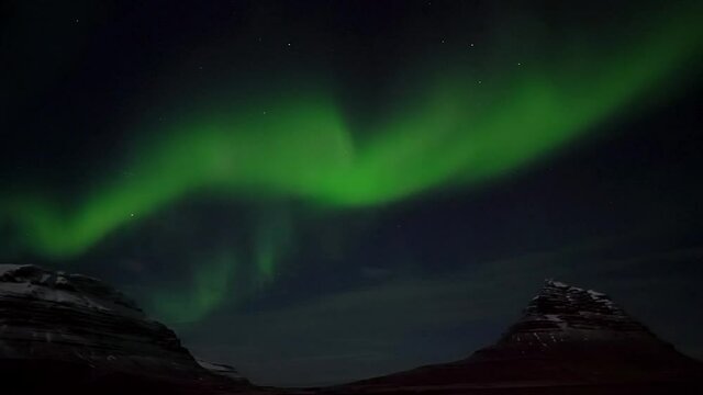 Strong And Active Northern Lights Above Kirkjufell Mountain in West Iceland - real time video.