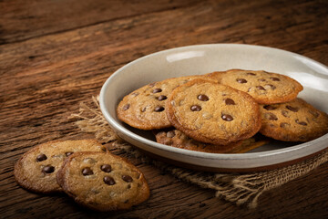 Delicious chocolate cookies on wooden table.