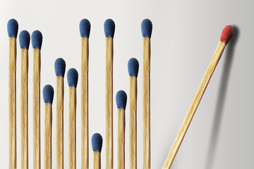 Wooden matches are lined up with a dozen blue matches on the left and one red match isolated and alone. This is a 3-D illustration.