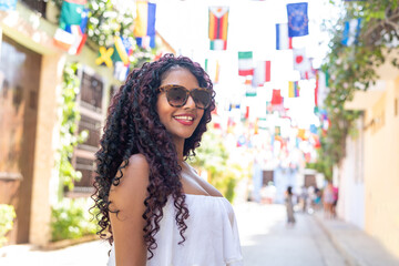 Beautiful local Colombian woman in white dress in the walled city of Cartagena, Colombia