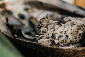 Close-up of sage bundle in bowl