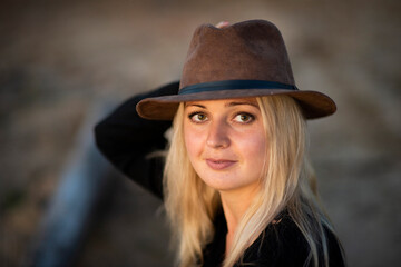 blonde girl in a hat in nature, selective focus