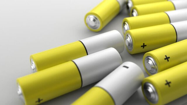 The yellow AA batteries are rolling on the table. 3d rendering